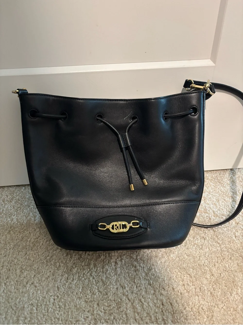 black leather drawstring bucket bag with shoulder or crossbody strap